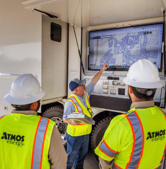 Atmos Energy employees talking through restoration plans at Mobile Command Unit