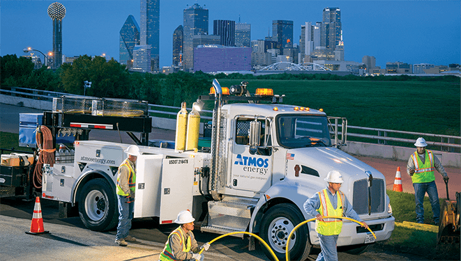 Atmos service truck foreground, Dallas skyline in background