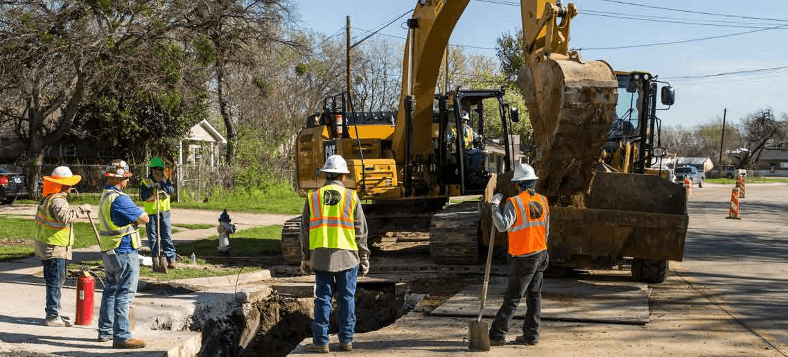 Image of Atmos team using an excavator truck on a neighborhood street