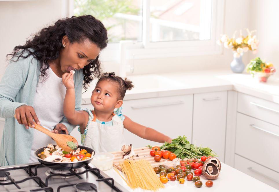 Mom daughter cooking