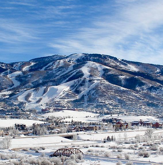 Small Colorado town in winter with large mountain in background